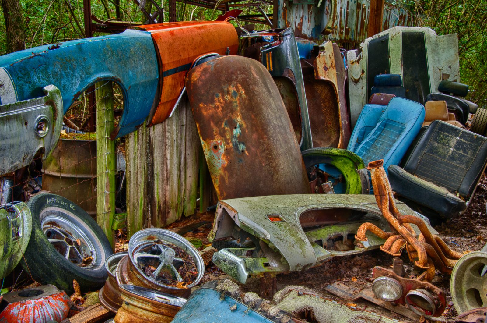 Weathered vehicles and parts in a salvage yard